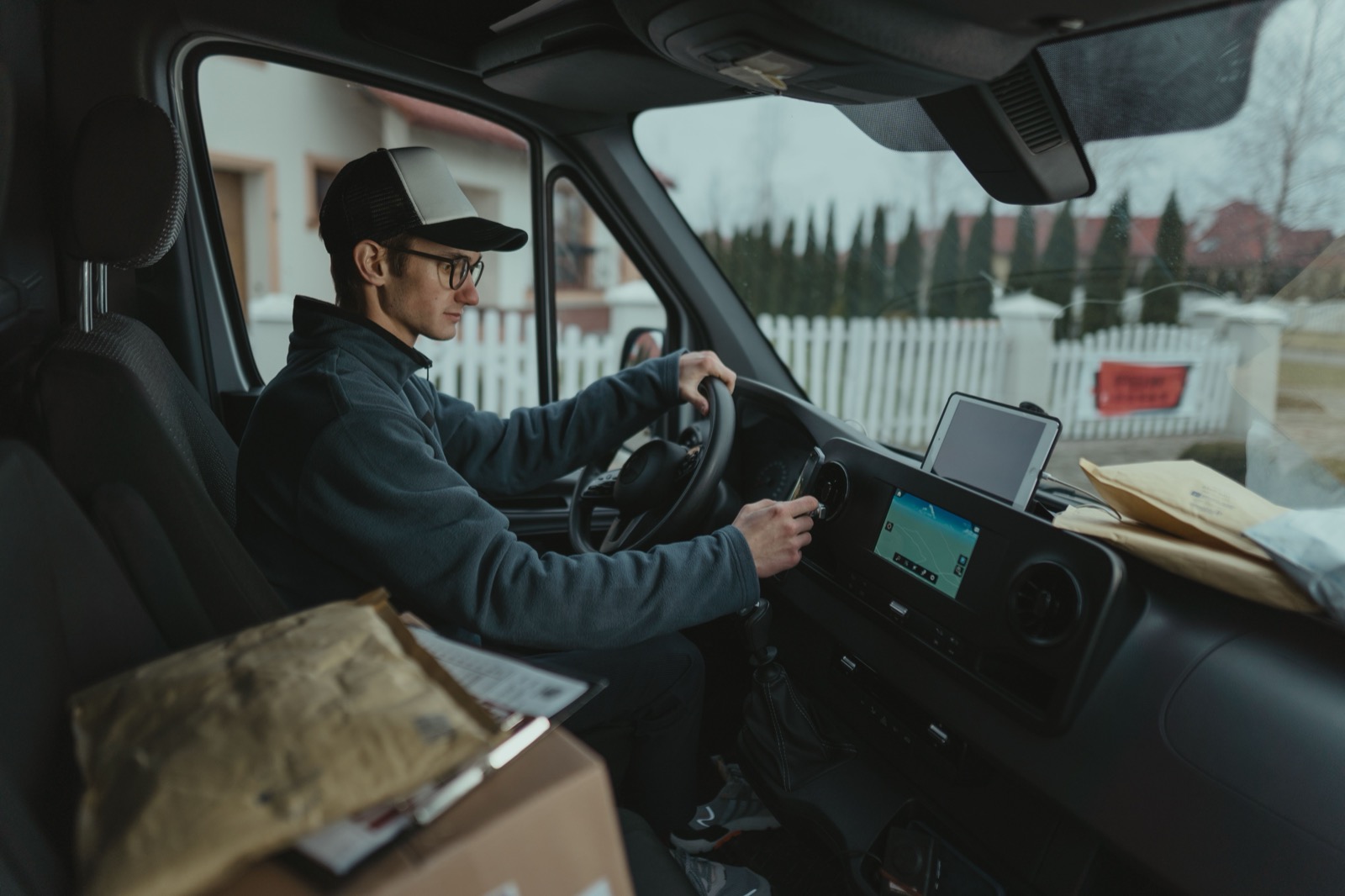 Courier following an optimized delivery route in a van loaded with packages